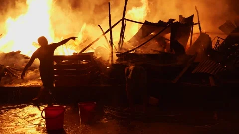 View of people fighting a massive fire at night, Bangladesh. Stock Footage 335562020