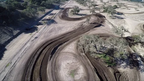 View as people gather at an empty former desert race track in slow motion Stock Footage 92104965