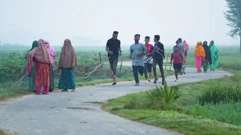 View of people jogging on a rural road in Bogura, Bangladesh. Stock Footage 335589865