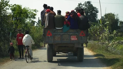 View of people riding in a tractor trailer in Dhangadhi, Nepal. Video stock 335475985