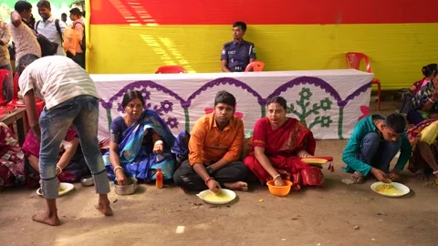 View of people sitting on the ground eating a meal in Bangladesh. Video stock 334987720