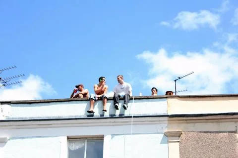 View of people sitting on rooftop. Stock Photos
