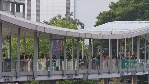 View of people using skywalk near Central World shopping mall. Stock Footage 284173437