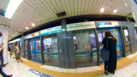 View of the people waiting on the side of the train in Osaka Japan Stock Footage 129278911