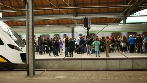 View of people waiting for the train and father sitting with his son platform Stock Footage 76039442