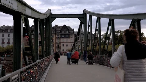 View of people walking aloong the Eiserner Steg iron bridge in Frankfurt Stock Footage 127943687