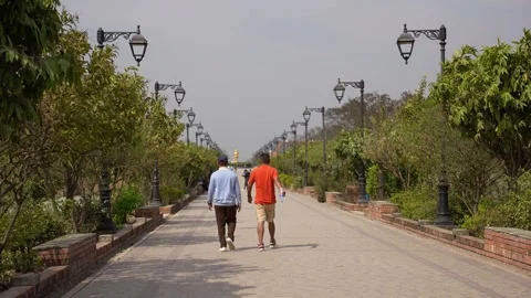 View of people walking on a path in Lumbini, Nepal. Video stock 335468659