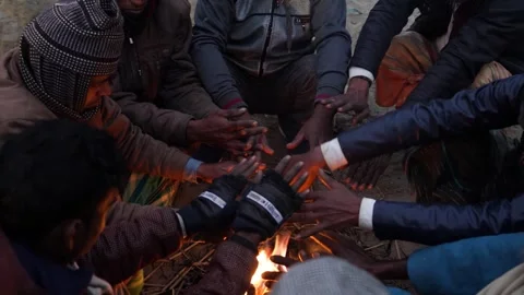 View of people warming hands by a fire in Bogura, Bangladesh. Video stock 335550825