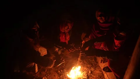 View of people warming their hands by a fire at night, Bangladesh. Video stock 335550912