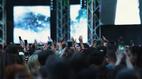 View of people waving hands dance have fun in a live concert festival music Stock Footage 118472916