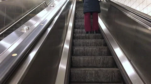 View of a person legs standing on an escalator Stock Footage 336256769