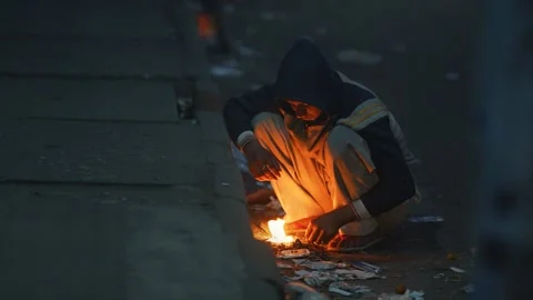 View of a person warming hands over a fire in Bogura, Bangladesh. 動画素材 335551182