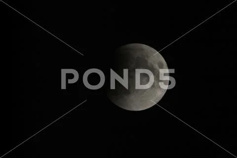 View, of a phase, of the lunar eclipse through a telephoto lens in Turin, Ita Stock Photos