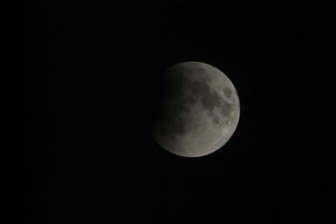 View, of a phase, of the lunar eclipse through a telephoto lens in Turin, Ita Stock Photos