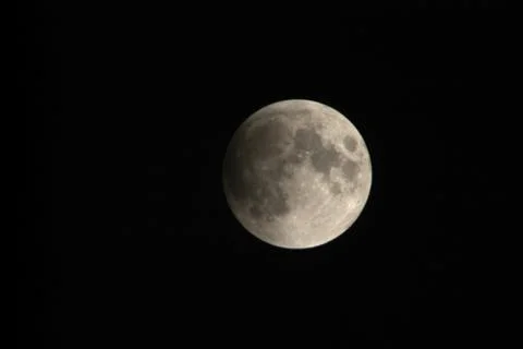 View, of a phase, of the lunar eclipse through a telephoto lens in Turin, Ita Stock Photos