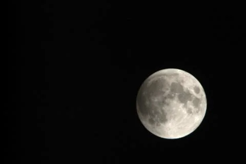 View, of a phase, of the lunar eclipse through a telephoto lens in Turin, Ita Stock Photos
