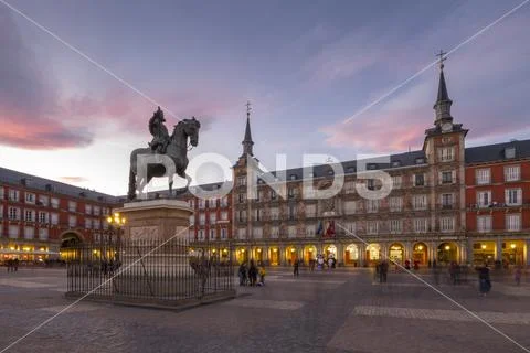 View of Philip lll statue and architecture in Calle Mayor at dusk, Madrid, Stock Photos