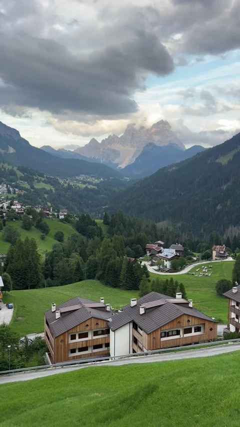 View of the Pian Fossal hamlet surrounded by green alpine meadows and mountains Video stock 334793465