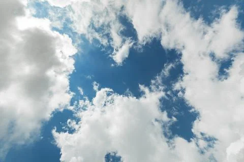 View of a piece of blue sky with white clouds at the edges of the frame, copy Stock Photos