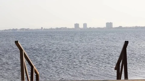 View of pier at the beach during summertime. Stockbeeldmateriaal 112973984
