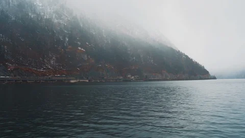 View from the pier of the lake to the mountains in the thick fog Stock Footage 105685357