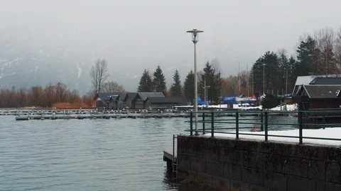 View from the pier of the lake to the mountains in the thick fog Stock Footage 105686085
