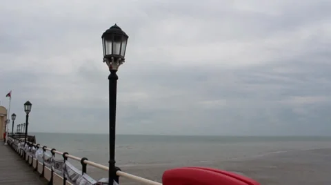View Of Pier Overlooking The Sea With Old Lamp ,Flag And Seagulls Video stock 37230936
