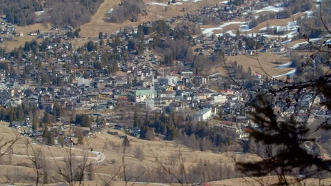 View from the pine tree dolomites forest of Cortina d'ampezzo town Stock Footage 306844061