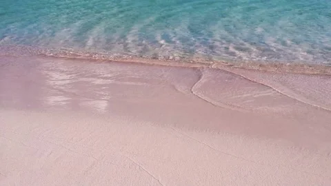 View of pink sand beach with calm sea waves. Stock Footage 133814867