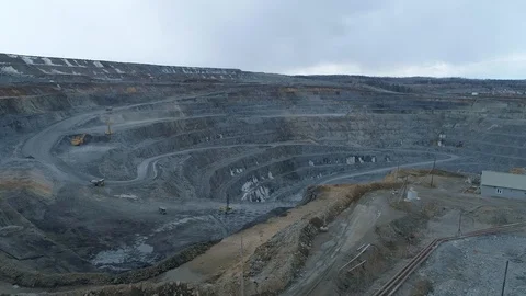 View of a pit on extraction of ore, work of trucks and an ekskvator Video stock 96565846