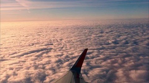 The view from the plane above the clouds during a beautiful sunset Stock Footage 106278709