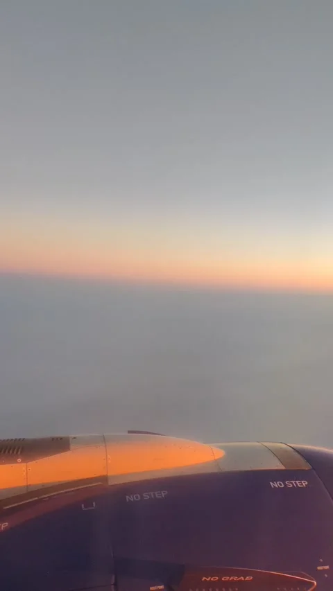 View from a plane from above the clouds at sunrise Stock Footage 142489094