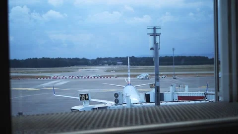 View of plane and its tail from airport terminal Perfect for aviation and travel Stock Footage 278117603