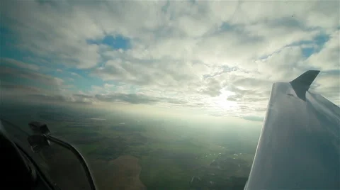 View from the plane cockpit to sky, clouds and earth from above Stock Footage 46304176