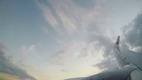 View from the plane flying over clouds on rising of the sun Stock Footage