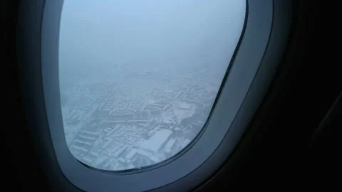 View from the plane gaining altitude on the snowy land Stock Footage 152306212