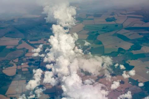 View from the plane to the ground and clouds. Travel concept. Stock Photos