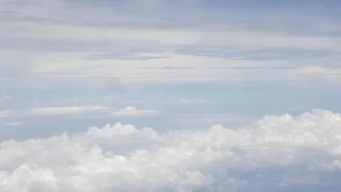View from plane over blue sky with dark grey Fluffy clouds while flying thr.. Stock Footage 297459555