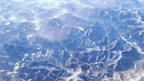 View from the plane to the snow covered mountains. Stock Footage 263712651