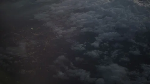 View from the plane through the clouds to the night city Stock Footage 87584133