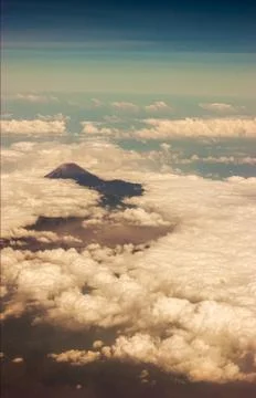 View from a plane of a volcano and the clouds in bali indonesia Stock Photos