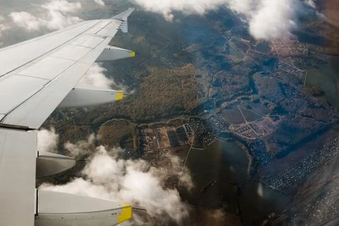 View from the plane window from above. Clouds and beautiful views of the city Stock Photos