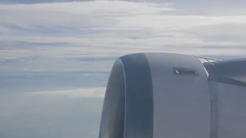 View from plane window of airplane engine while airplane flying over sky. 動画素材 331304245