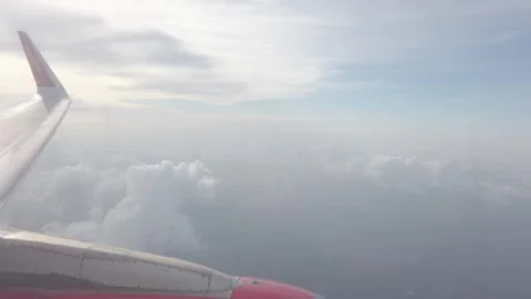 View from plane window of airplane's engine while airplane flying over sky .. Stock Footage 337929507