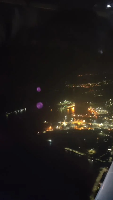A view from a plane window of beach cost sea port On a night Stock Footage 142489237
