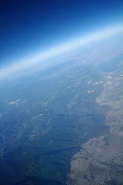 View from the plane window to the clouds and the earth Stock Photos
