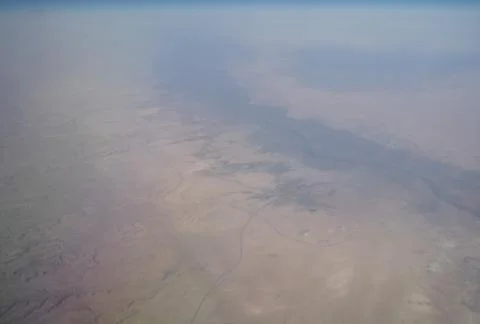 View from the plane window to the clouds and the earth Stock Photos