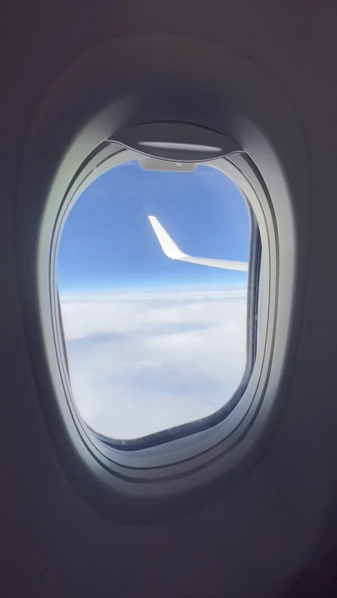 View of plane window during flight over the clouds Stock Footage 336912987