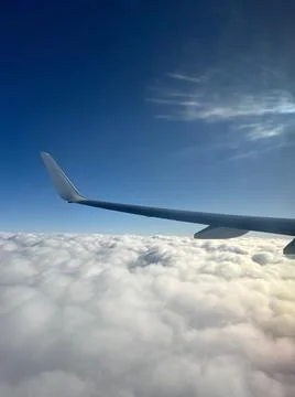 View from the plane window. Flight, journey above the clouds. Flying wing Foto stock