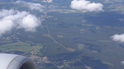 View from the plane window. Flying in an airplane over cities, lakes, forests 4K Stock-Footage 121878429
